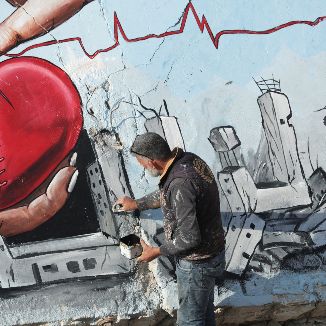 Syrian artists paint mural on rubble in Jandaris